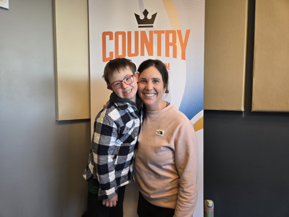 Caleb Reykdal and Deanna Talbot pose for a photo in the Country 93 studios on the morning show