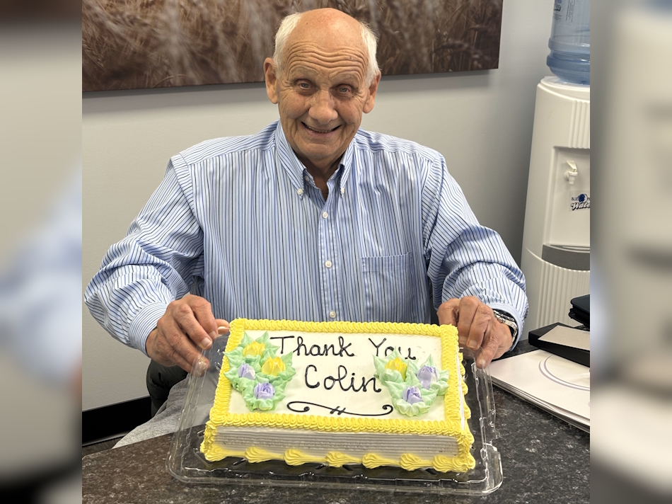 Colin Wilcox with his surprise congratulatory cake in the board room of CPCS