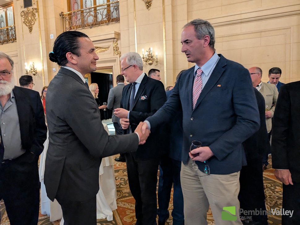 a man shakes hands with Manitoba Premier Wab Kinew