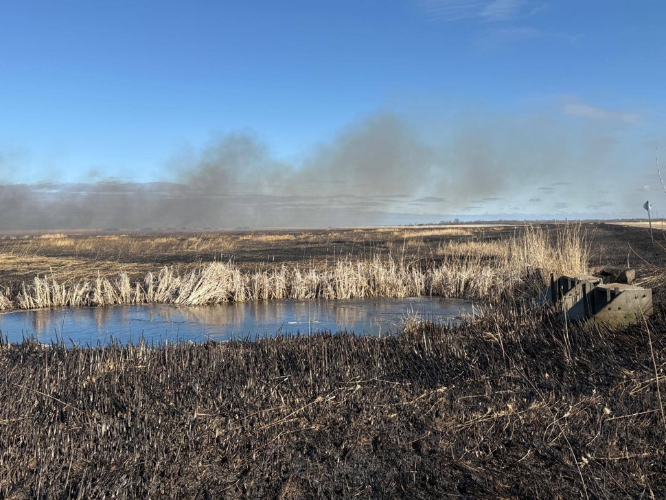 Fire burns in a field near St. Ambroise