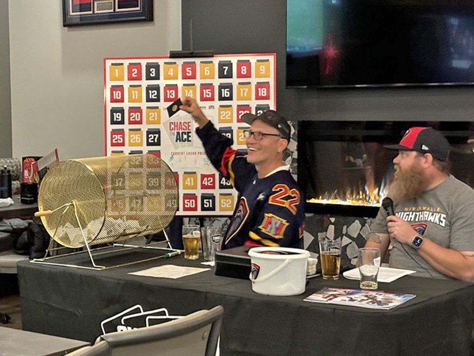 Ray Dowse (left) pulling the first card chosen back in September 2024. 