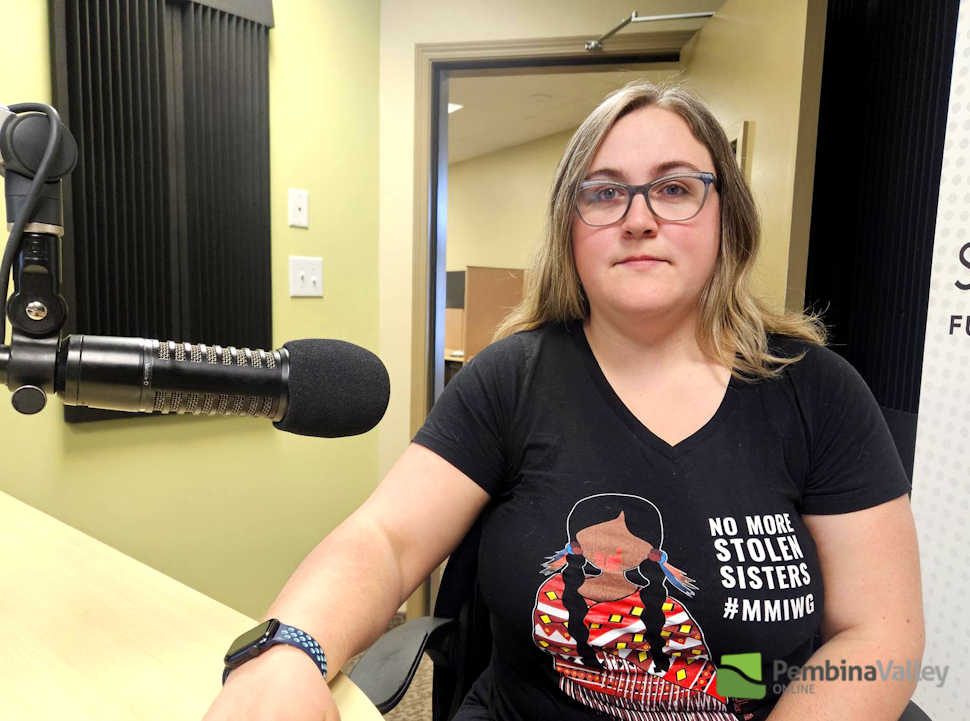 a woman sits in a studio