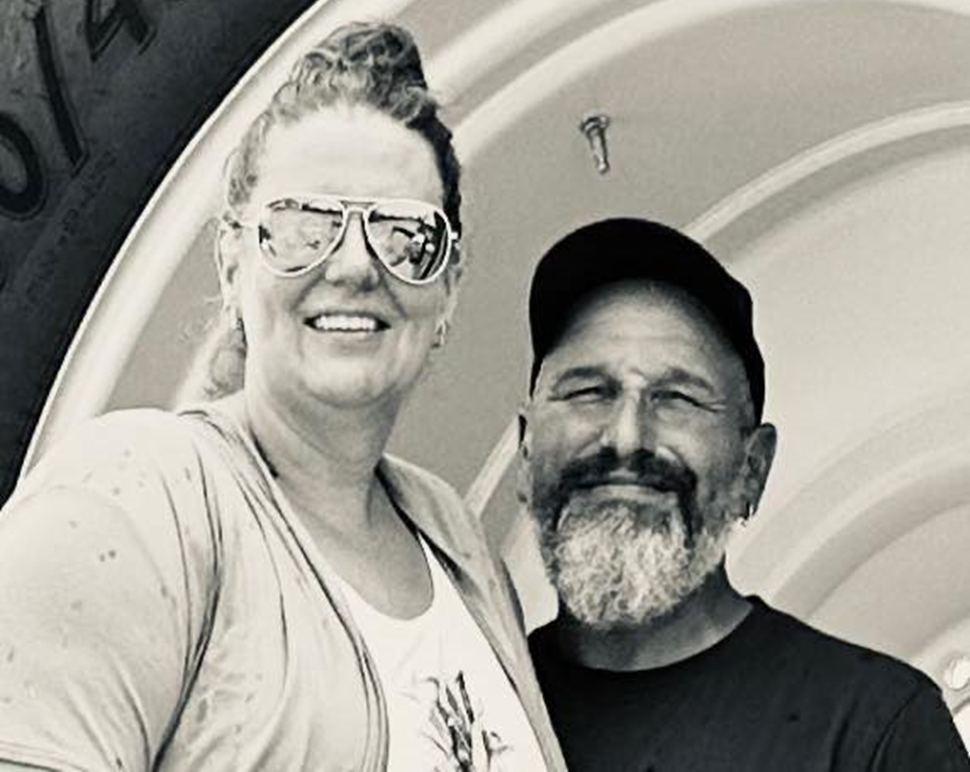 Tanya & John Laterveer sitting on a tractor tire.