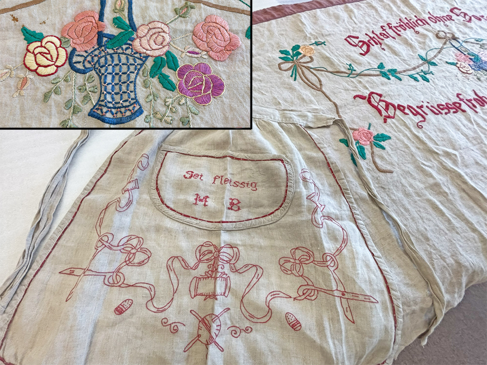 Donated apron and headboard covering show the detail and care given to embroidery by Maria Braun.