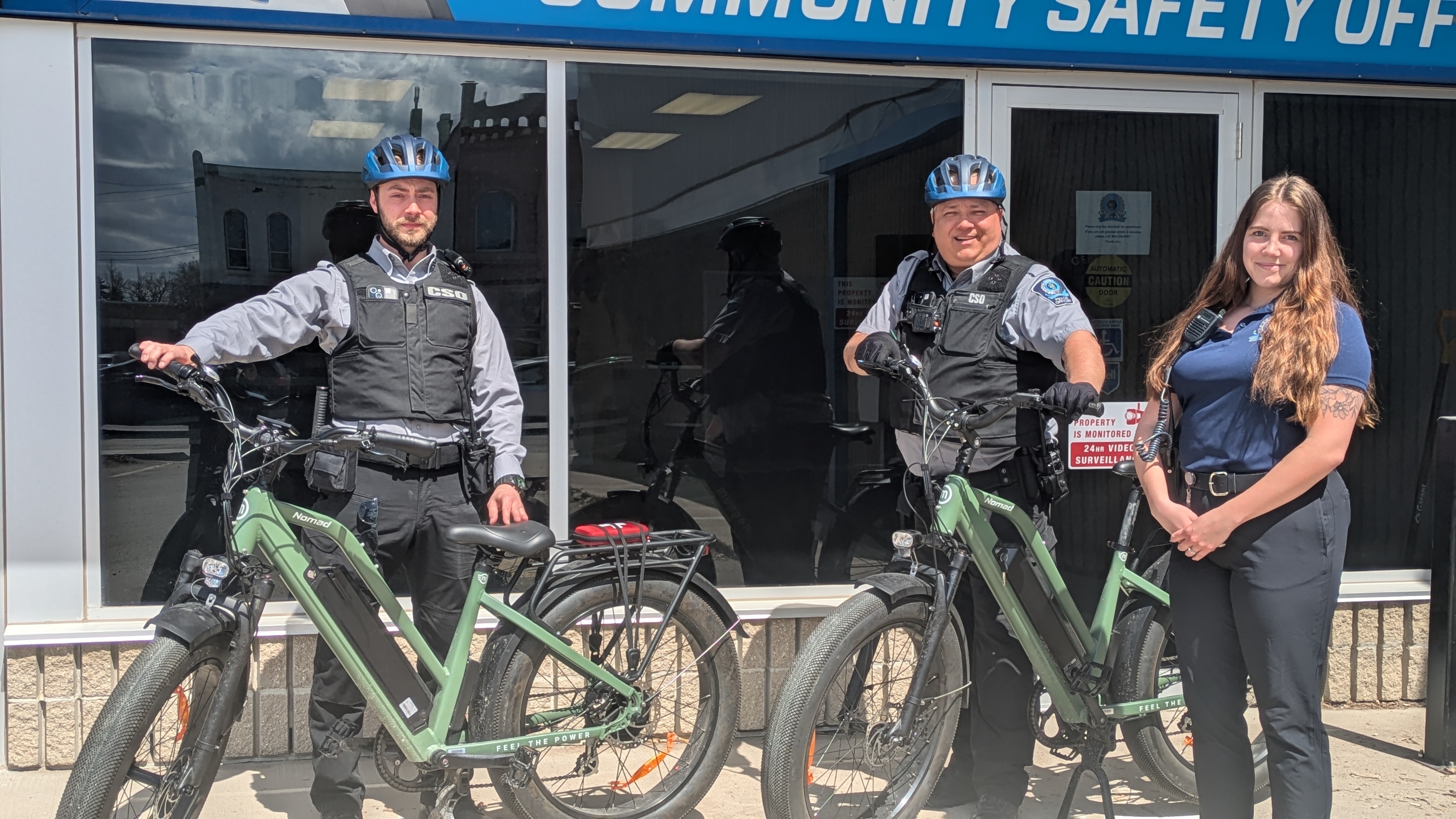 Lukas Kanne, Todd Allard, and Caitlyn Saindon with E-bikes outside of CSO office