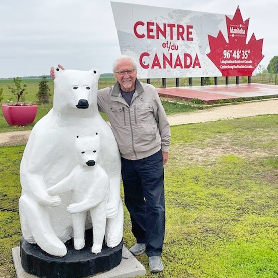 Bernie Penner, local chainsaw carver with polar bears he created, as the Centre of Canada Park (photo submitted)