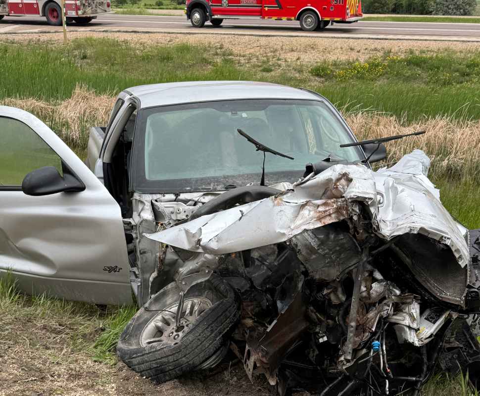 a pickup with a properly destroyed front end sits in a ditch