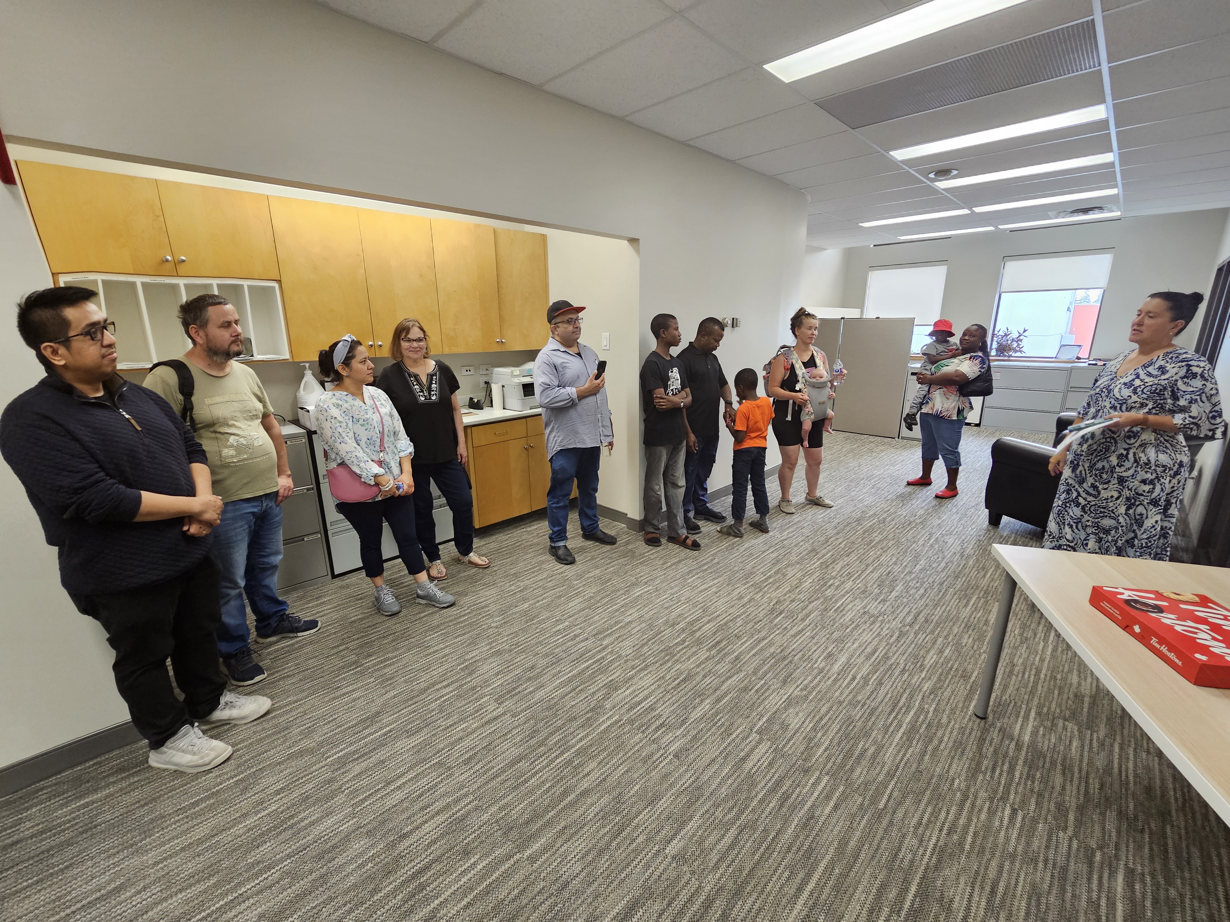 The group stands outside the Mayor's office, hearing more about the history of the building