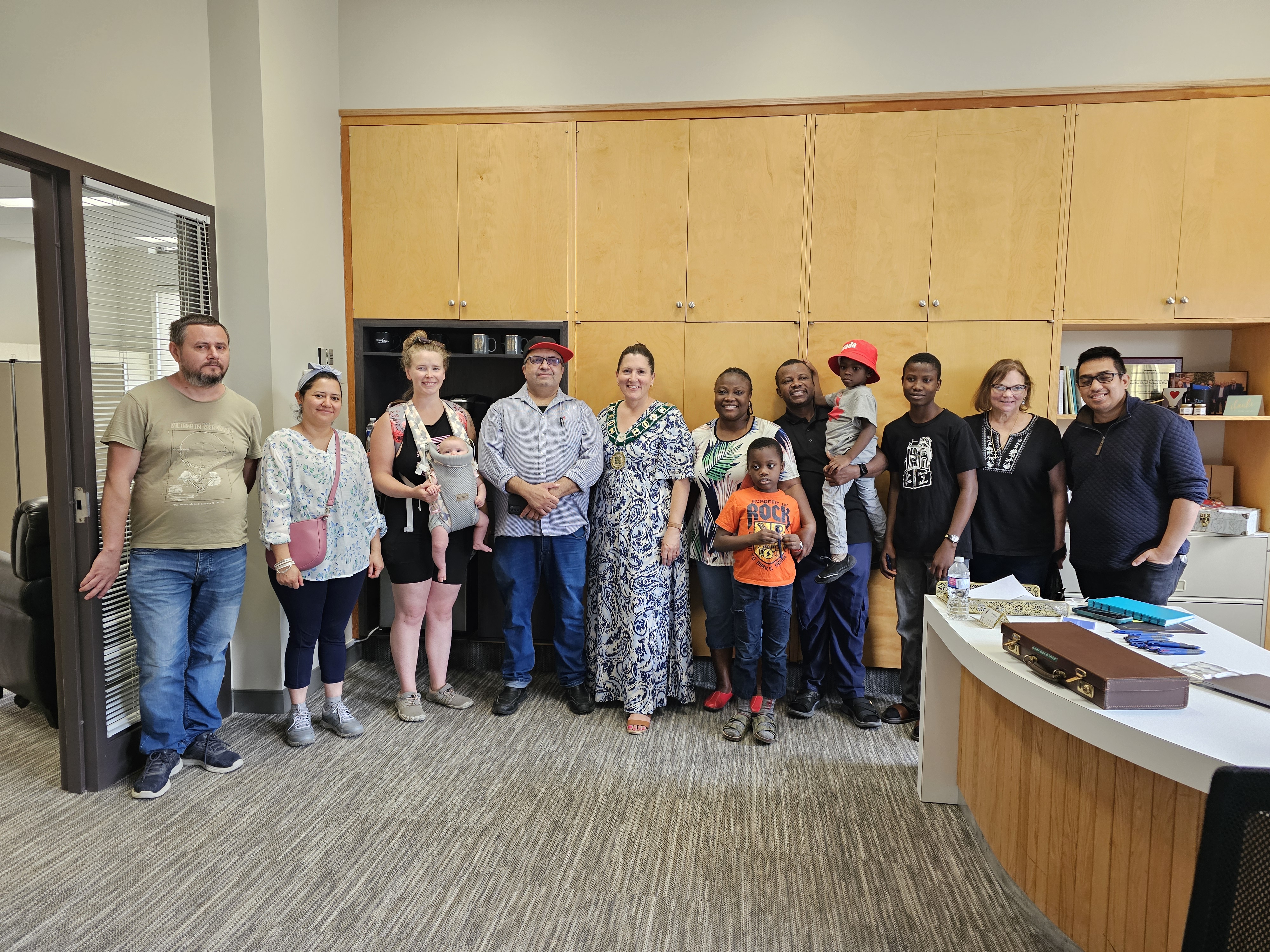 The group stands for a group photo with Mayor Knox in her office