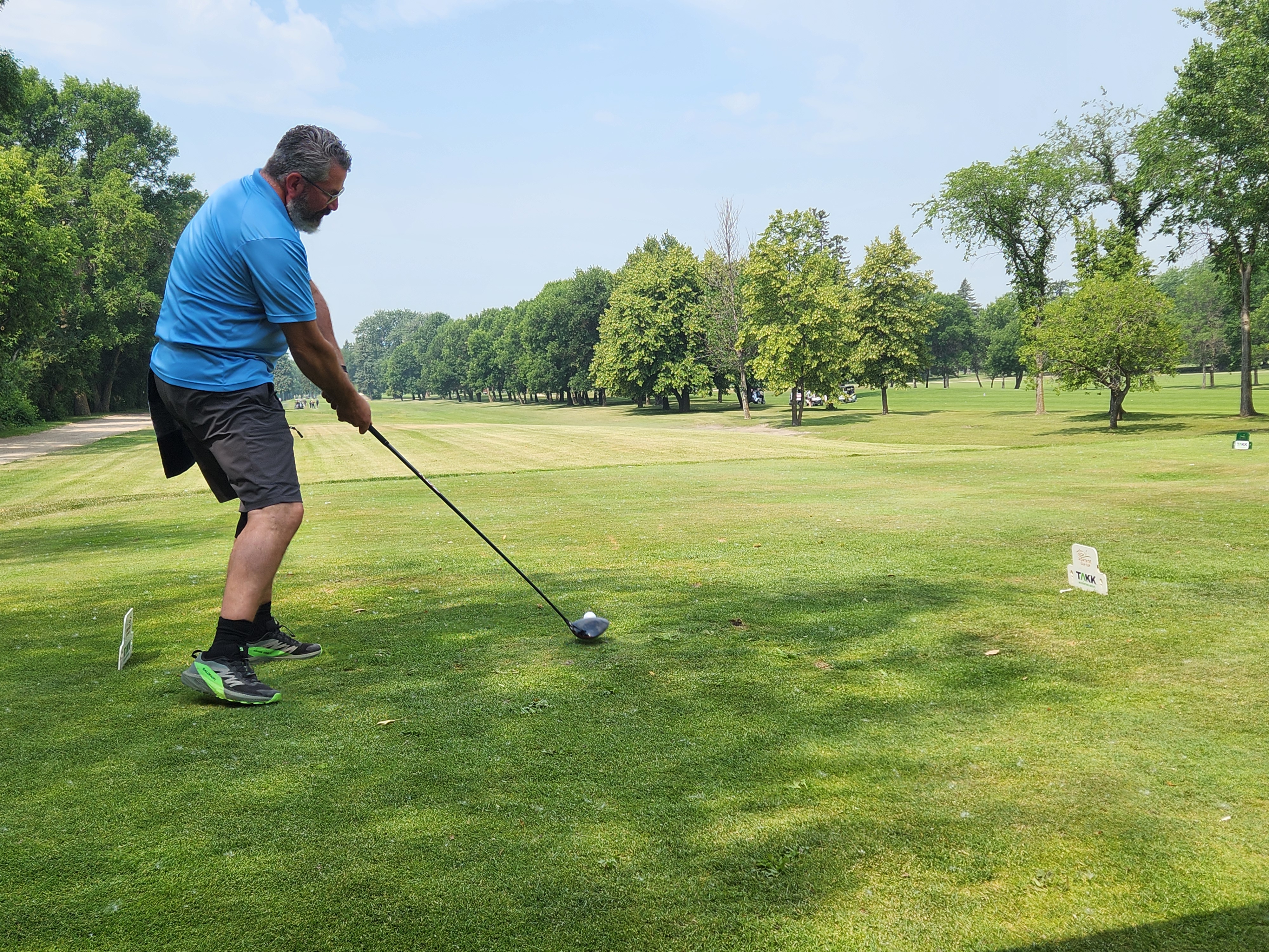 A golfer follows through on a strong drive under hot, humid skies during Stride’s fundraising tournament at Portage Golf Club. PortageOnline/ Tristen Sokolosky