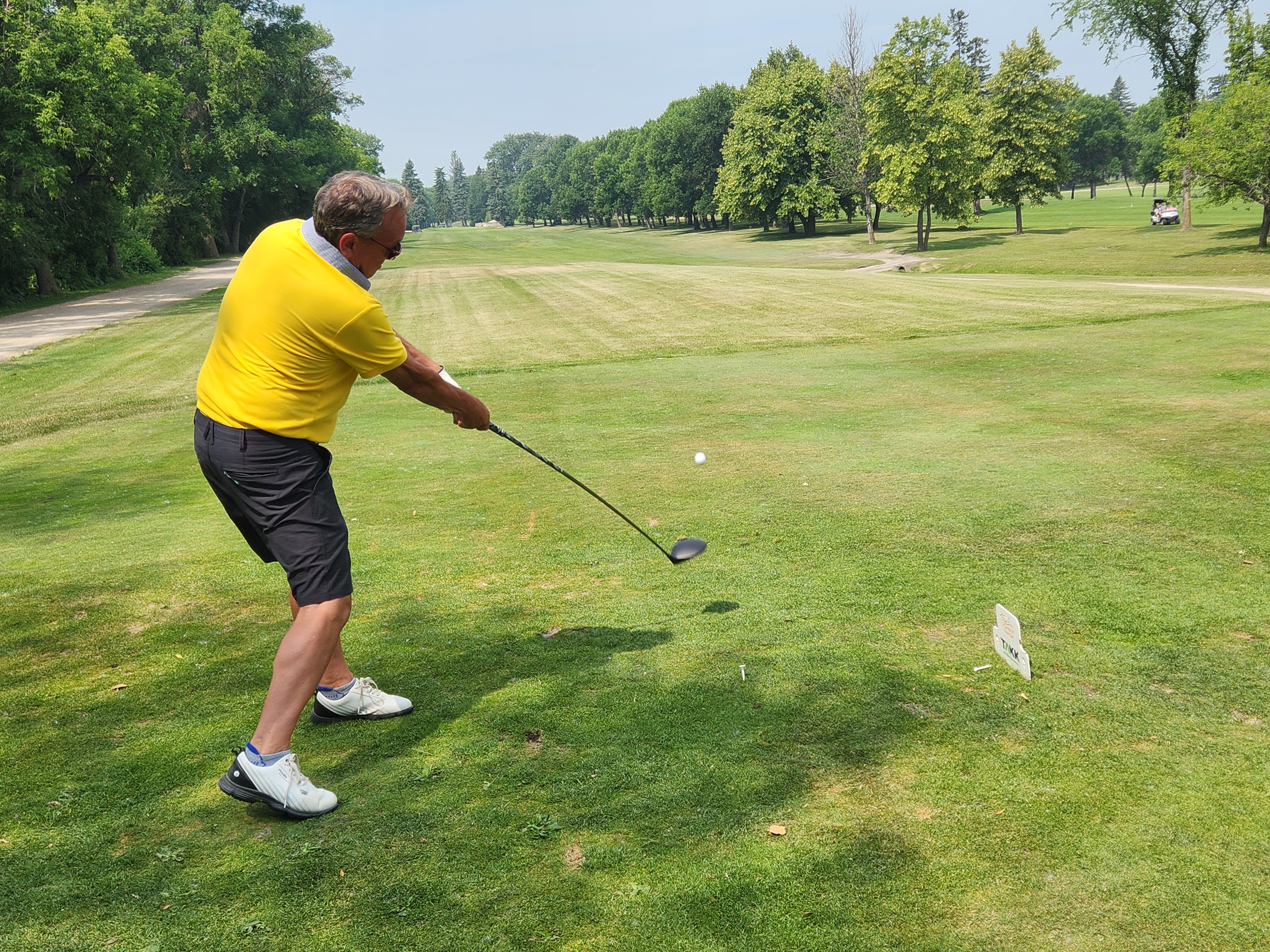 A golfer follows through on a strong drive under hot, humid skies during Stride’s fundraising tournament at Portage Golf Club. PortageOnline/ Tristen Sokolosky