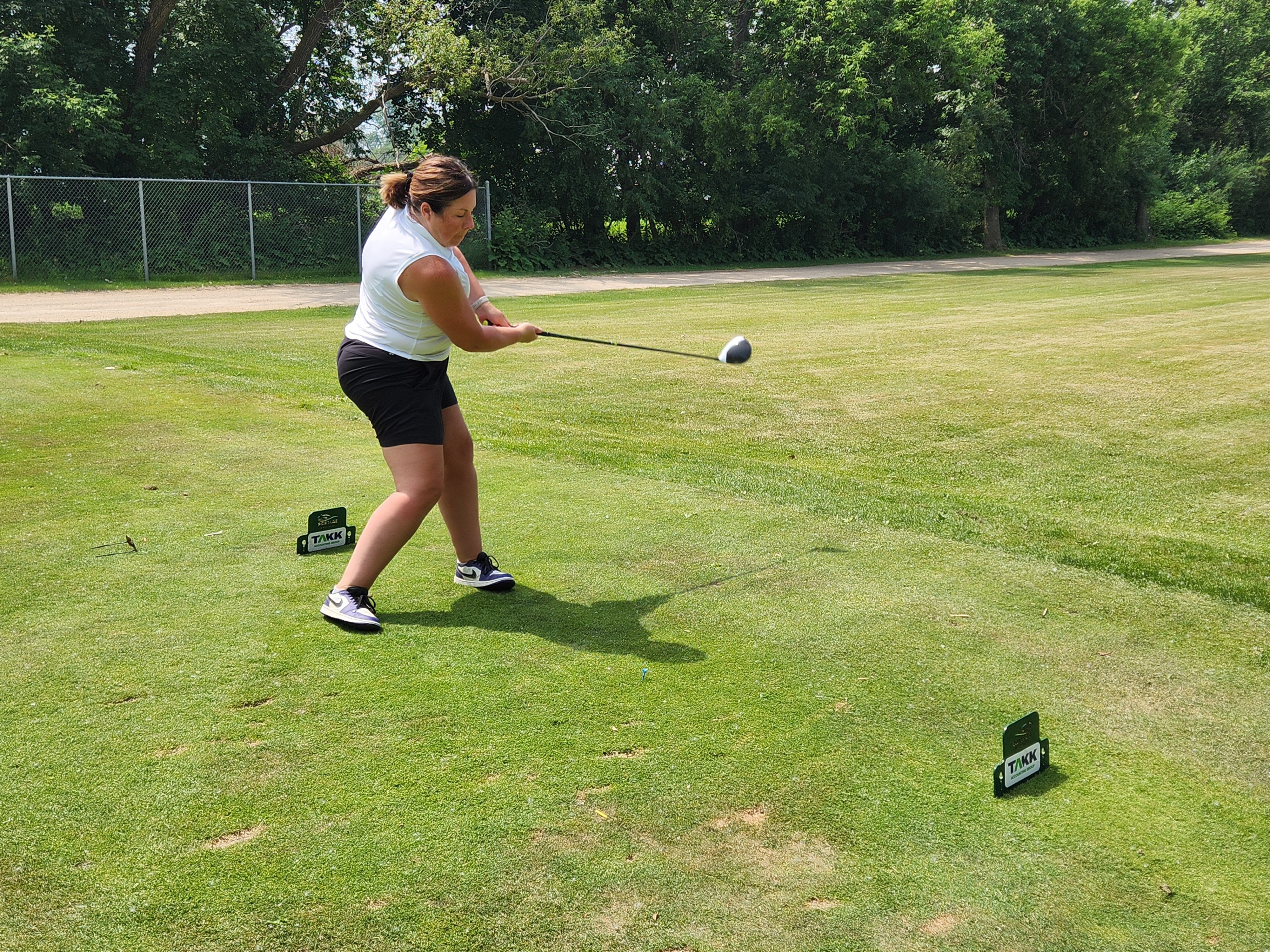 A golfer follows through on a strong drive under hot, humid skies during Stride’s fundraising tournament at Portage Golf Club. PortageOnline/ Tristen Sokolosky