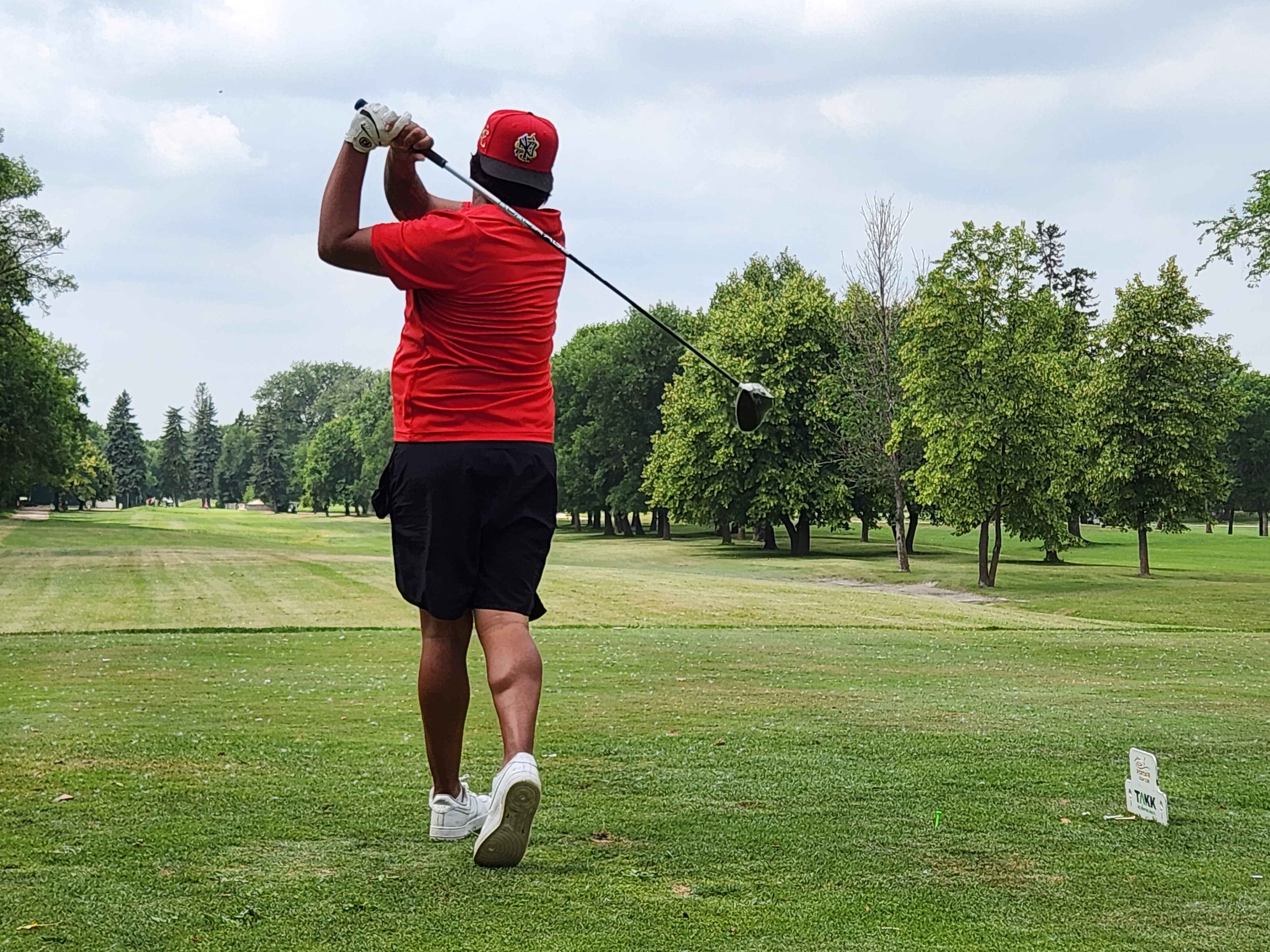 A golfer follows through on a strong drive under hot, humid skies during Stride’s fundraising tournament at Portage Golf Club. PortageOnline/ Tristen Sokolosky