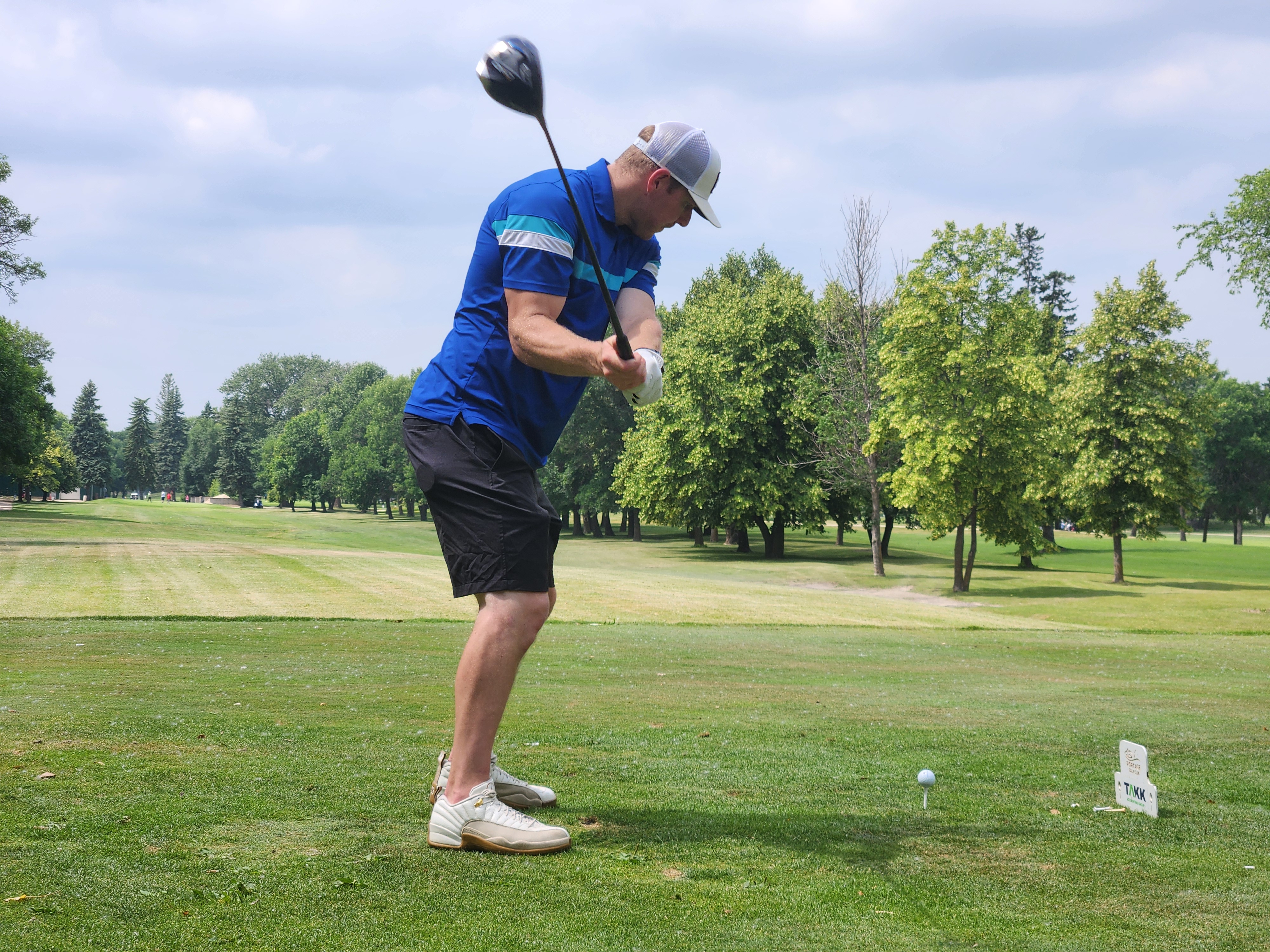 A golfer follows through on a strong drive under hot, humid skies during Stride’s fundraising tournament at Portage Golf Club. PortageOnline/ Tristen Sokolosky
