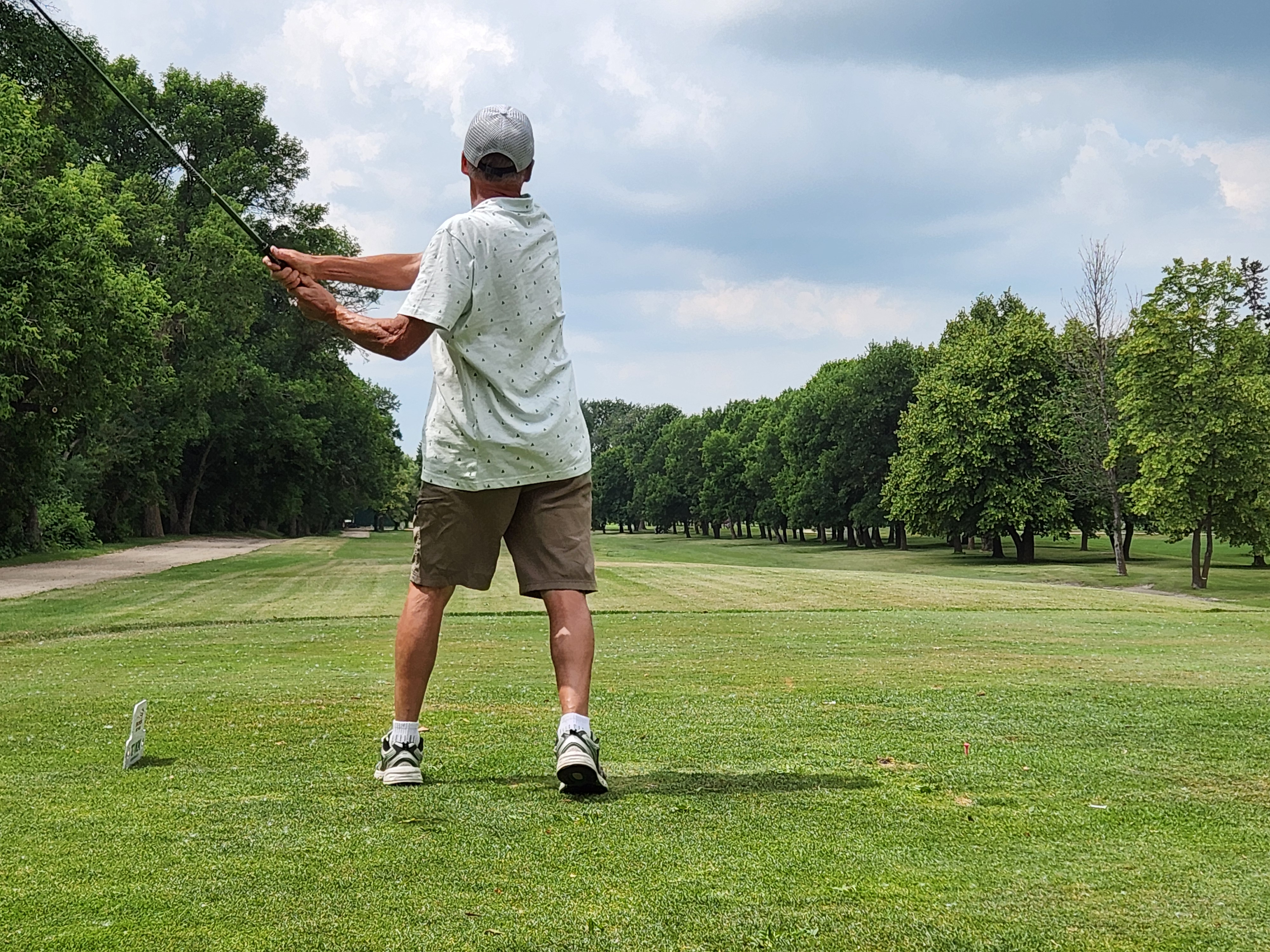 A golfer follows through on a strong drive under hot, humid skies during Stride’s fundraising tournament at Portage Golf Club. PortageOnline/ Tristen Sokolosky