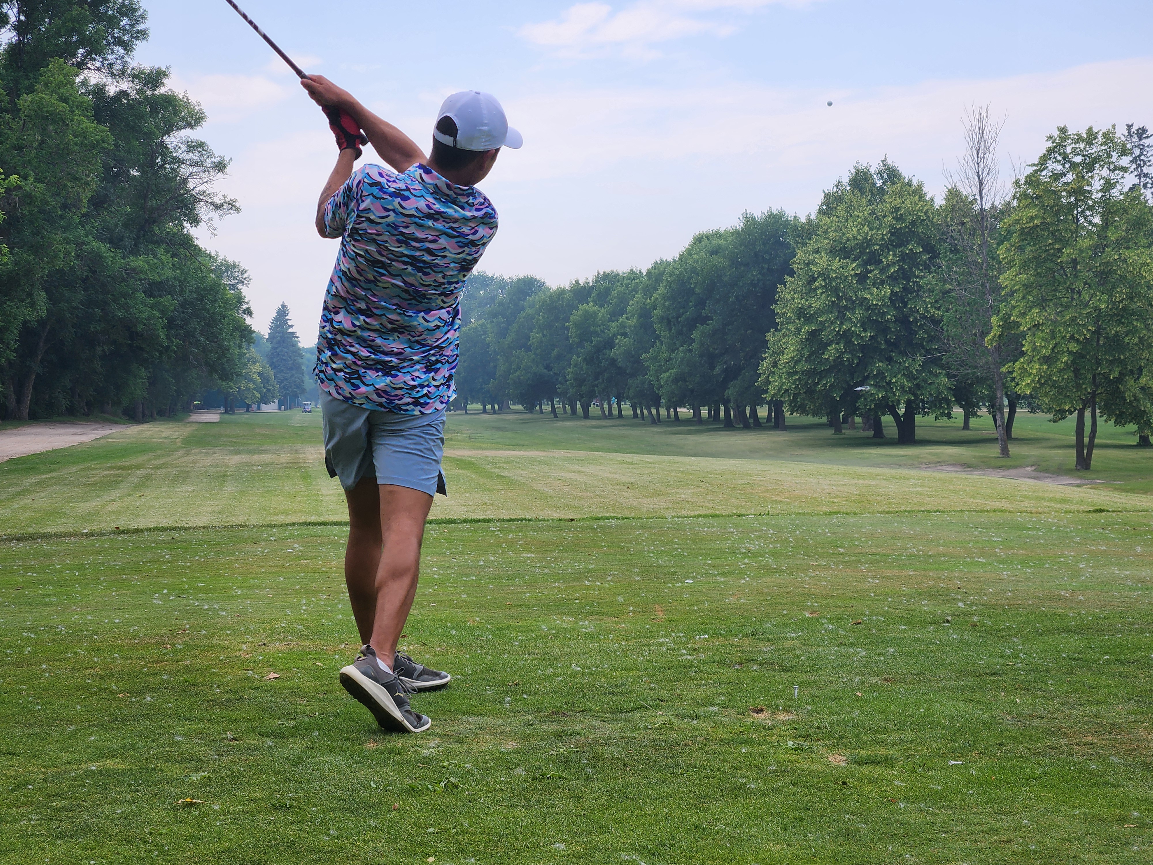 A golfer follows through on a strong drive under hot, humid skies during Stride’s fundraising tournament at Portage Golf Club. PortageOnline/ Tristen Sokolosky