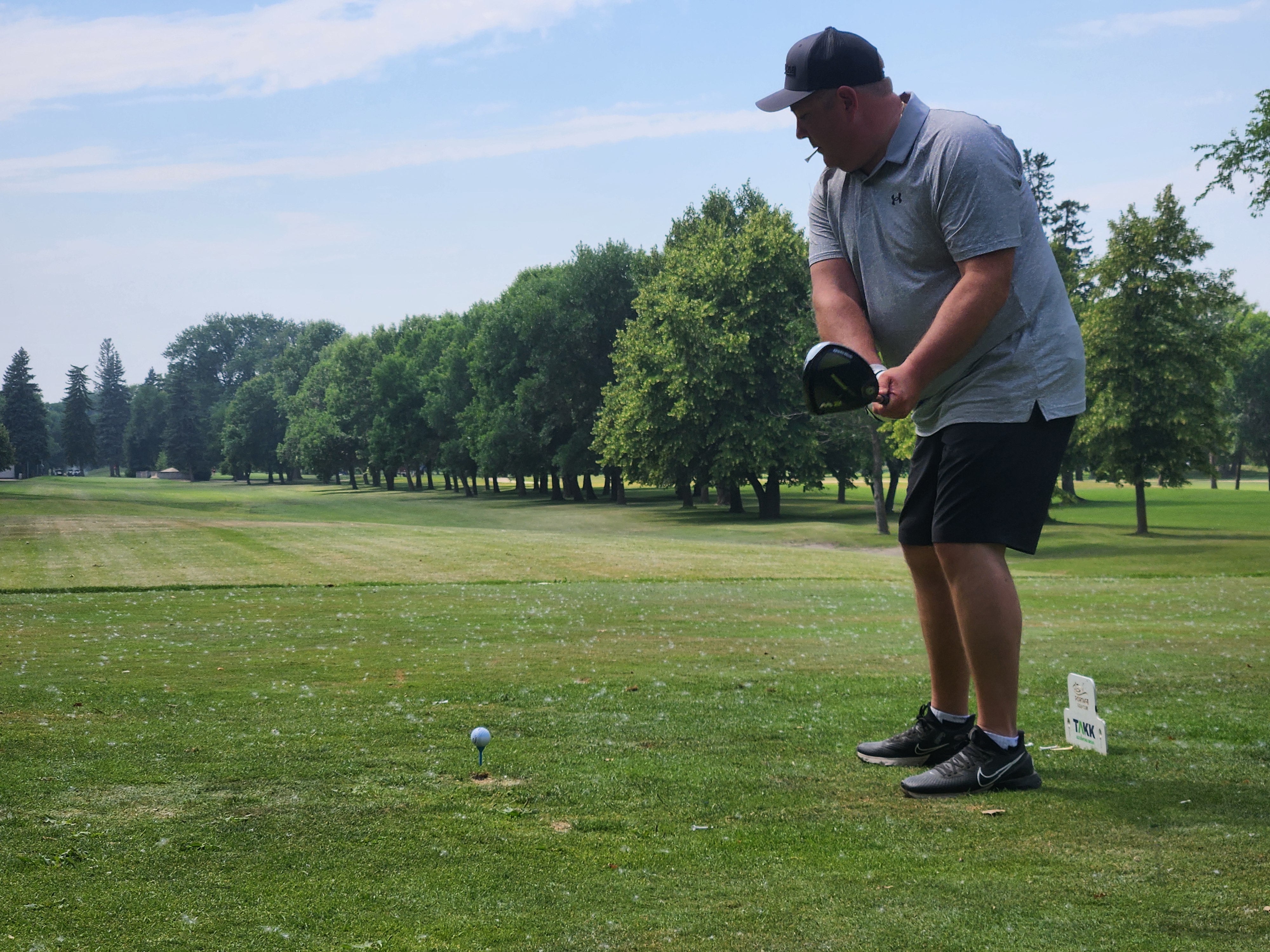 A golfer follows through on a strong drive under hot, humid skies during Stride’s fundraising tournament at Portage Golf Club. PortageOnline/ Tristen Sokolosky