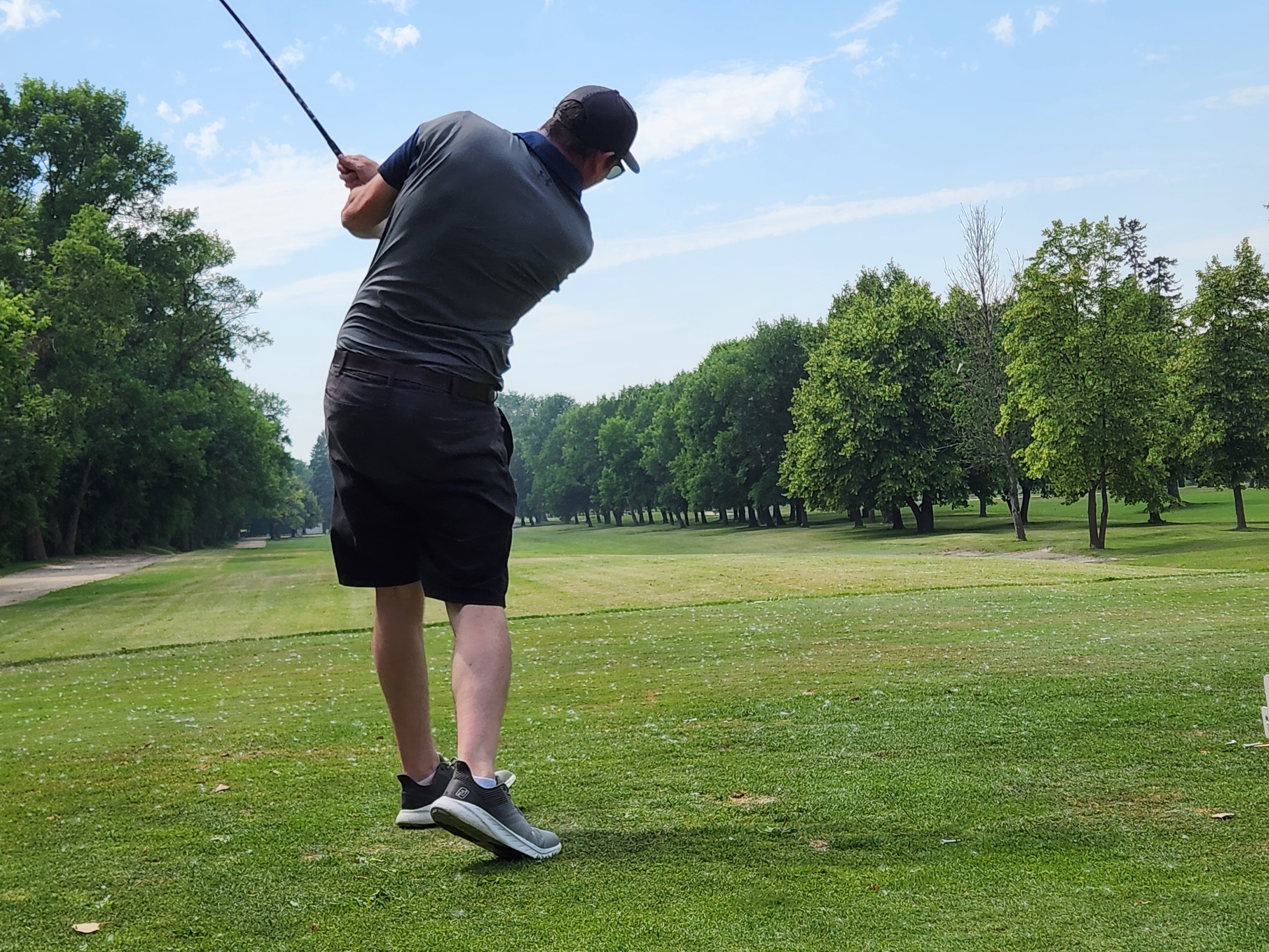 A golfer follows through on a strong drive under hot, humid skies during Stride’s fundraising tournament at Portage Golf Club. PortageOnline/ Tristen Sokolosky