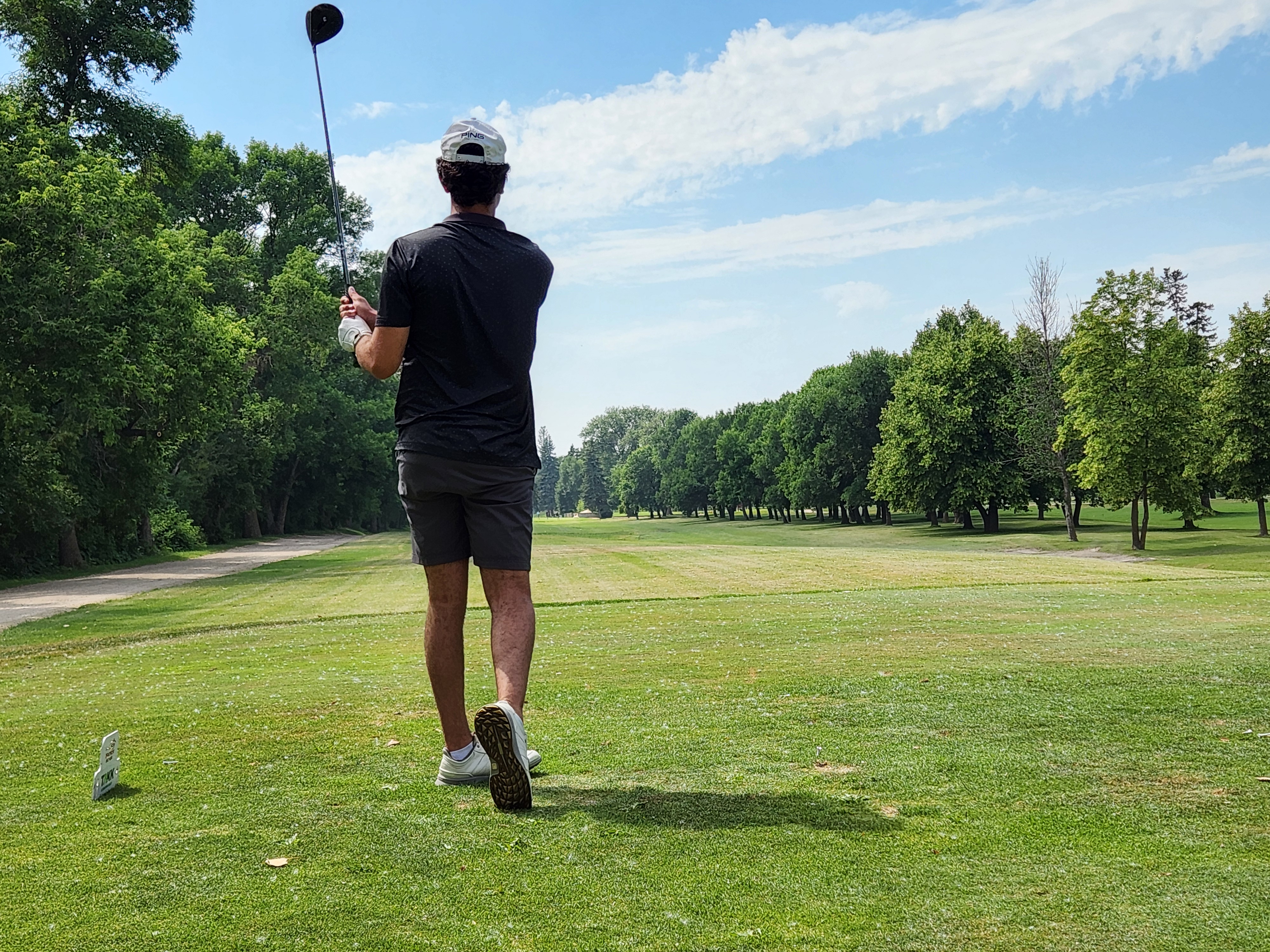 A golfer follows through on a strong drive under hot, humid skies during Stride’s fundraising tournament at Portage Golf Club. PortageOnline/ Tristen Sokolosky