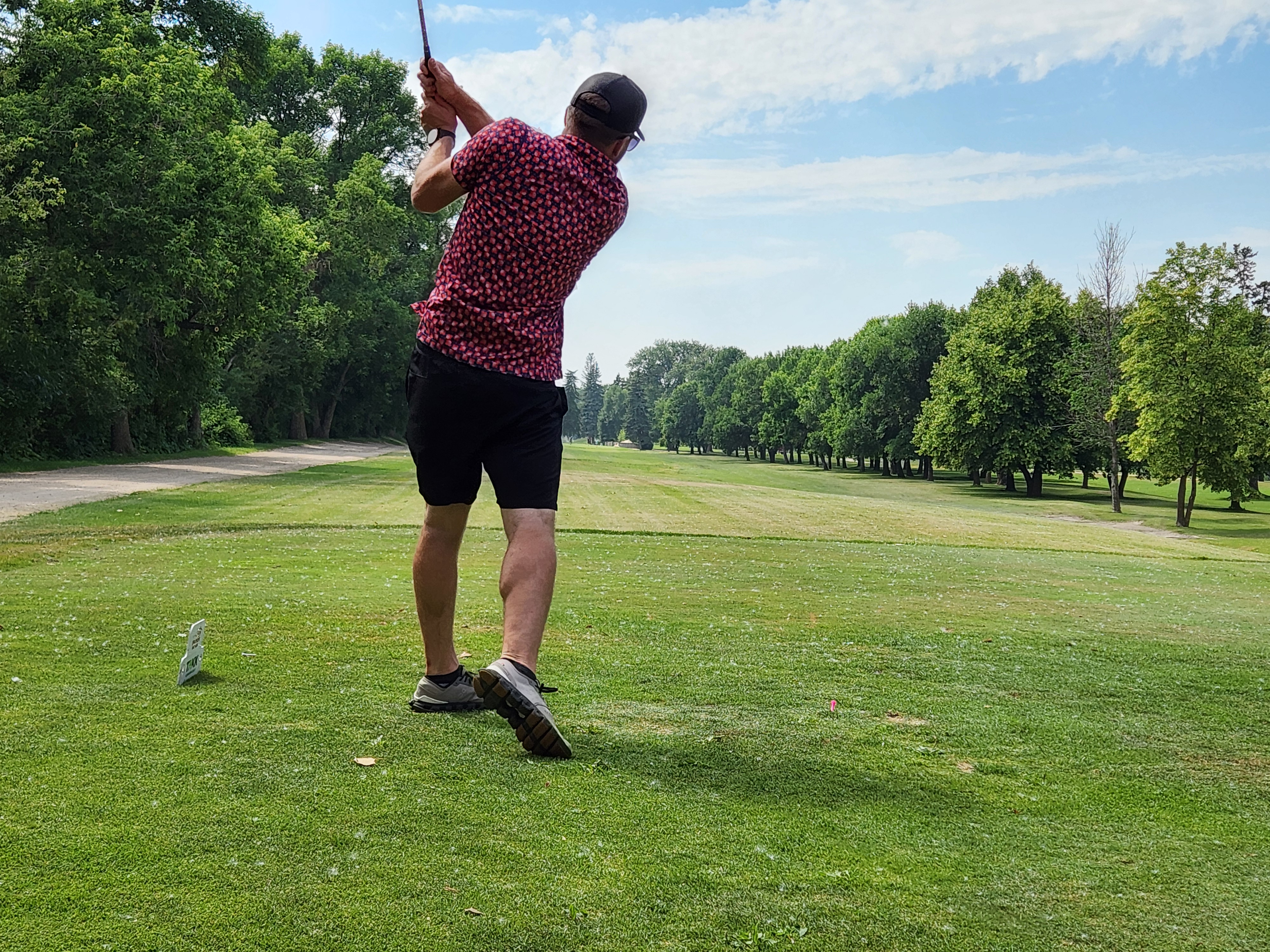 A golfer follows through on a strong drive under hot, humid skies during Stride’s fundraising tournament at Portage Golf Club. PortageOnline/ Tristen Sokolosky