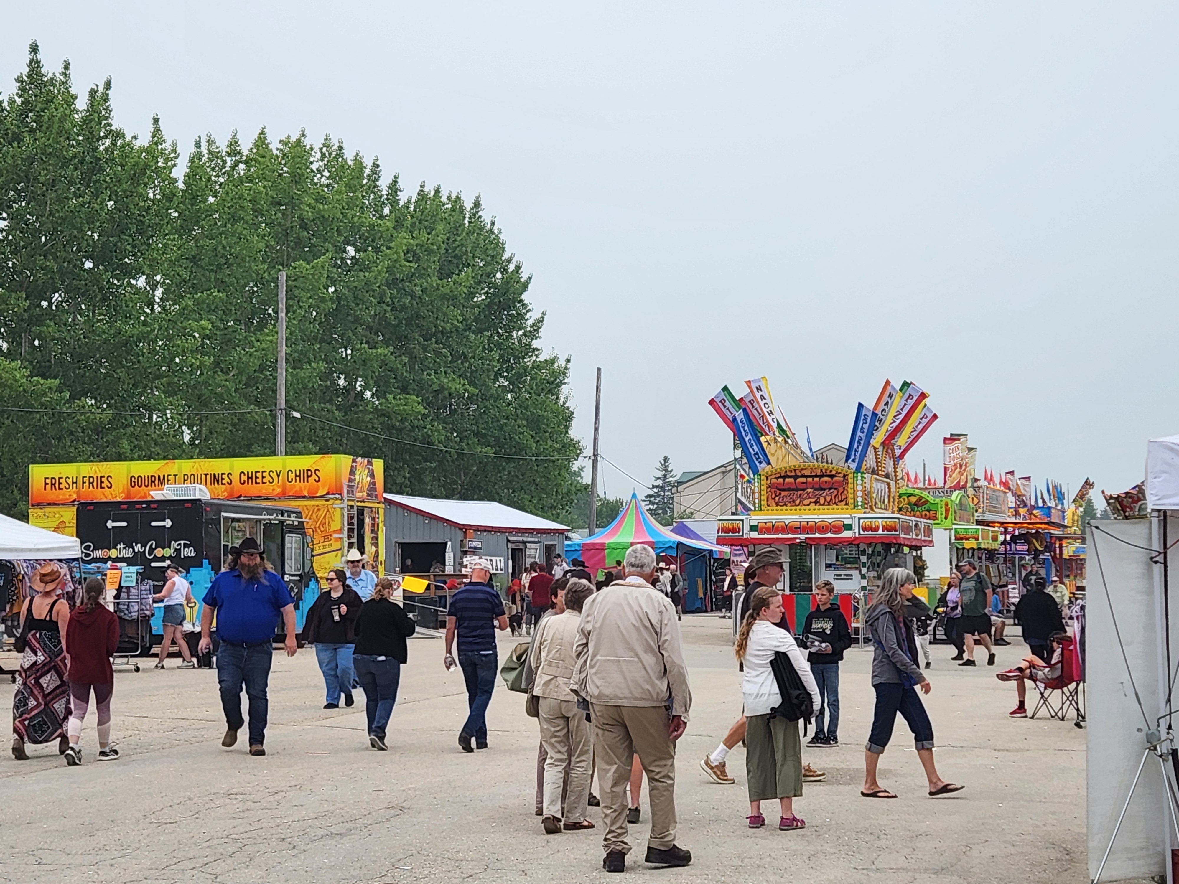 Crowds gather under cloudy skies for a fun-filled afternoon at the Morris Stampede Midway, where colourful rides, carnival games, and family memories take center stage. PortageOnline/ Tristen Sokolosky
