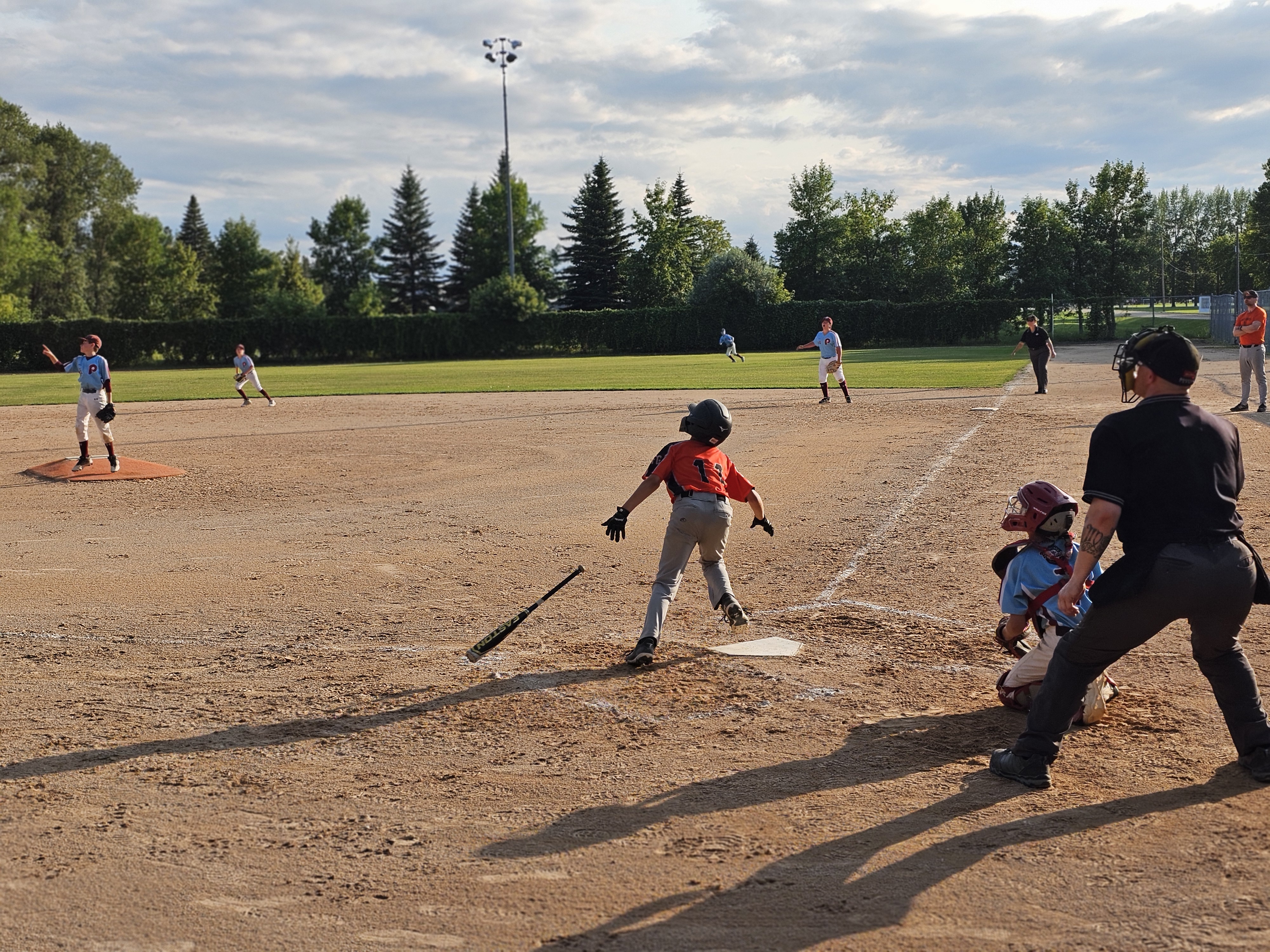 One of the Fort Garry Giants bats a heavy hitter, sending the ball nearly out of the park