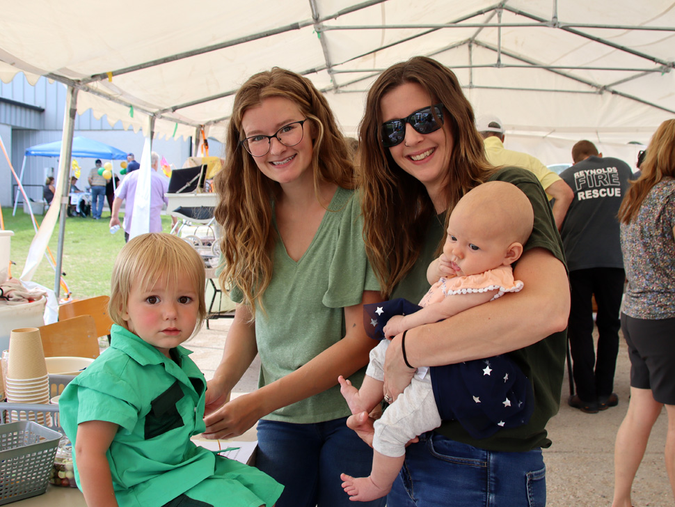 Families gathering under a tent at Woodridge's 125th anniversary