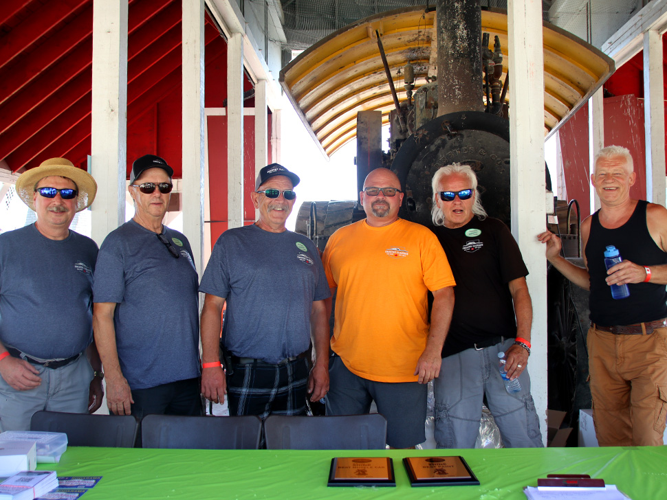 Car guys stand together at the Mennonite Heritage Village for the show n' shine