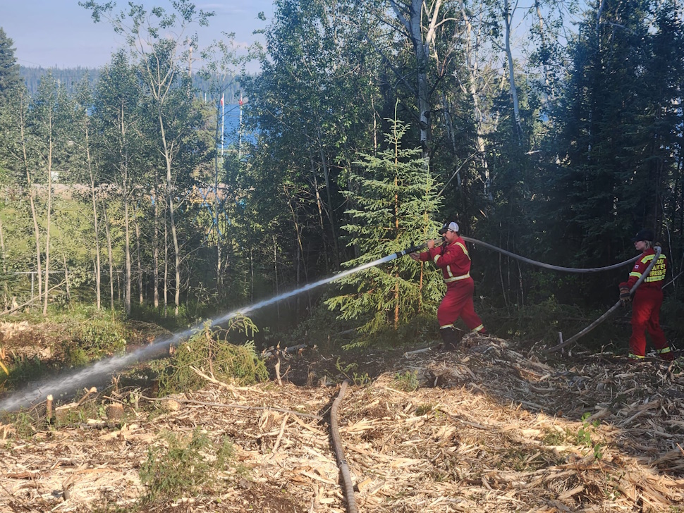 Steve Slaney and Amber Lynn Knutt from Emerson-Franklin Fire Department helping with fire protection in Snow Lake