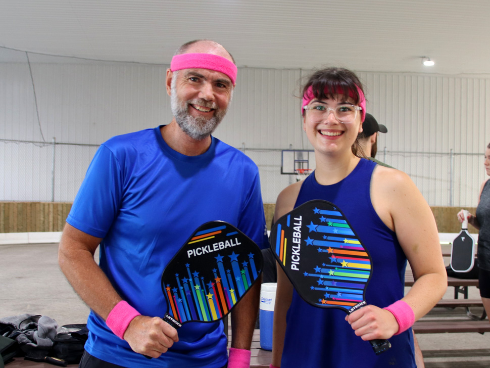 Father Daughter Duo holding pickleball paddles
