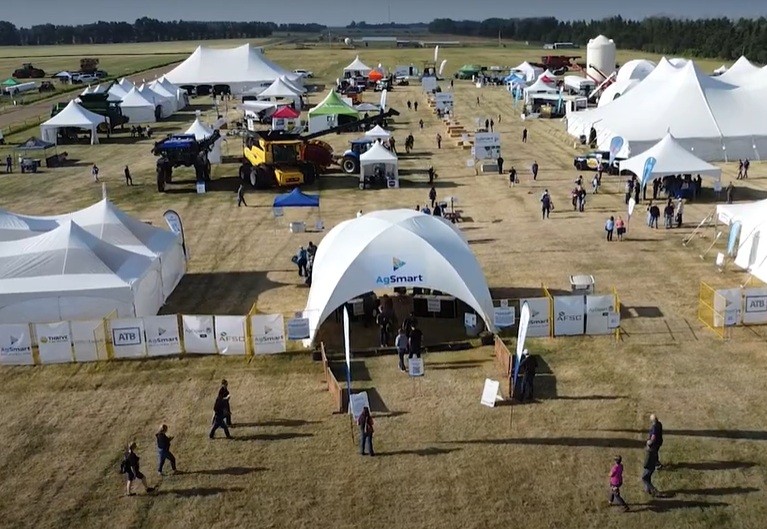aerial view of the site at Olds College with tents, equipment and people walking around