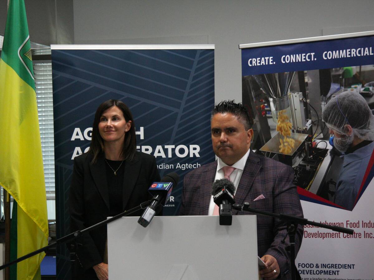  Laura Mock and Mehmet Tulbek at a podium to announce Cultivator-Food Centre partnership