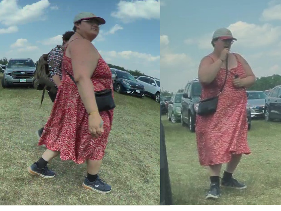 a woman walking in a grass parking lot