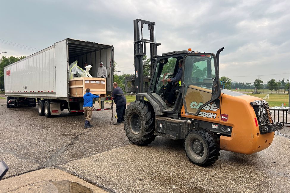 a forklift unloading a semi-trailer