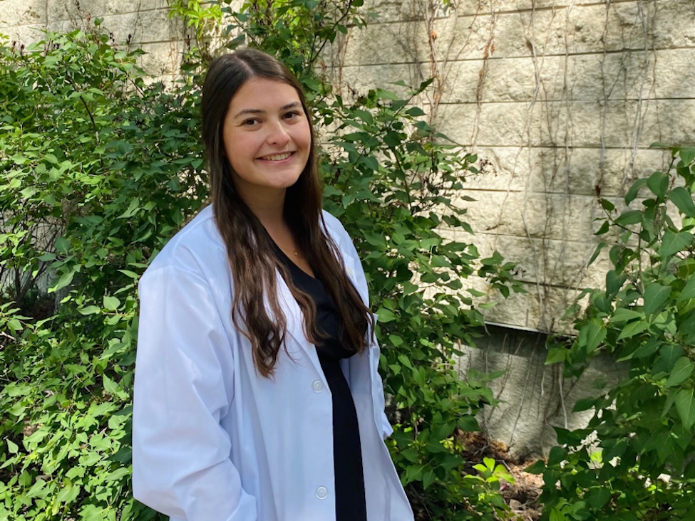 a young lady wearing a lab coat