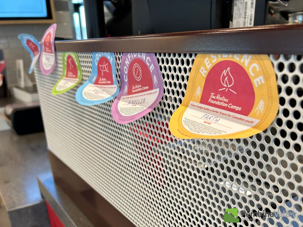 donation badges on a counter at Tim Hortons