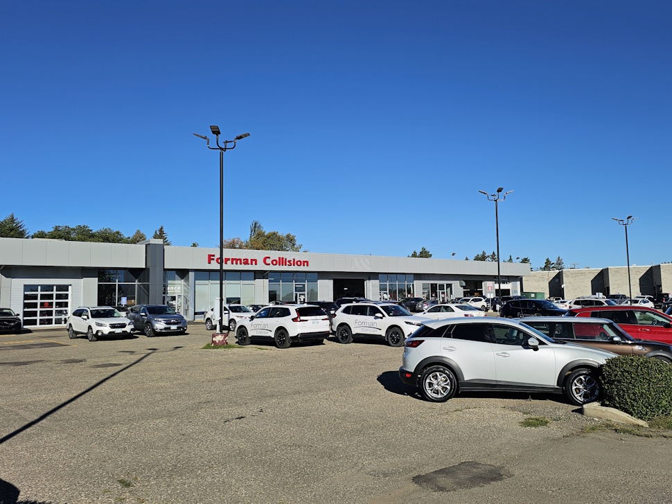 a zoomed out view of a repair shop parking lot