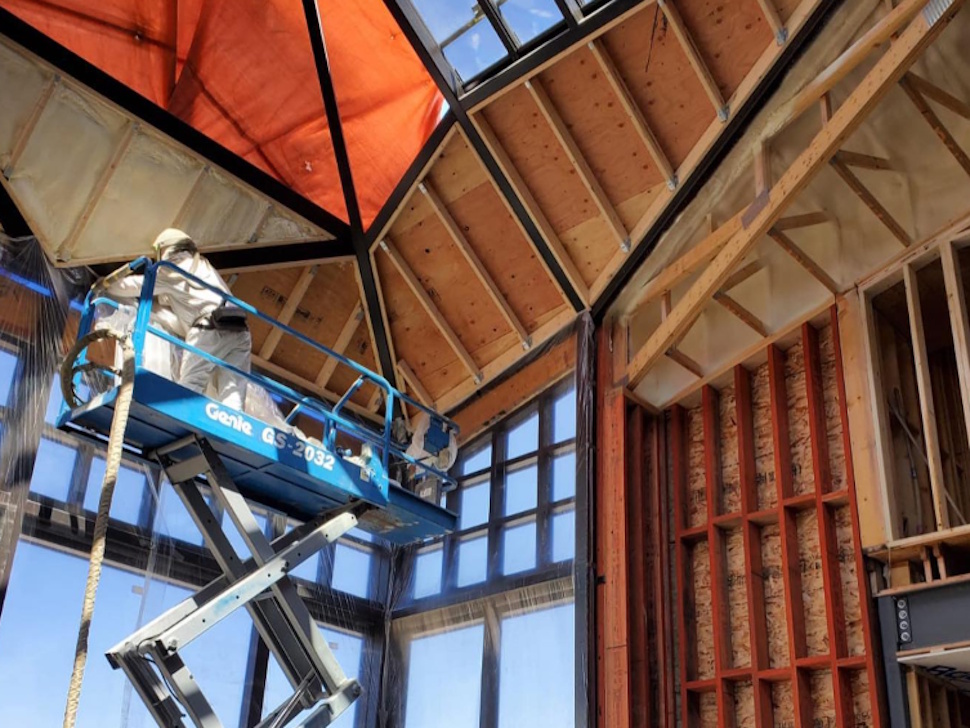 a person on a lift putting in installation