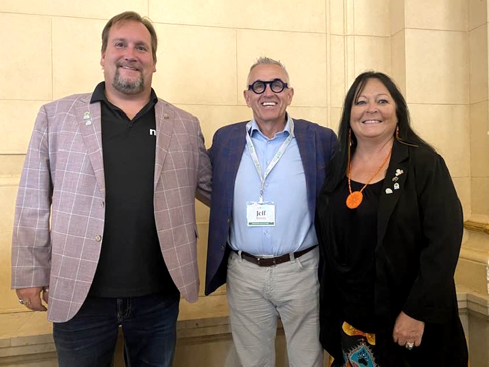 Jeff Bereza stands with two attendees at the Canadian Federation of Agriculture Summer Meeting in Winnipeg.