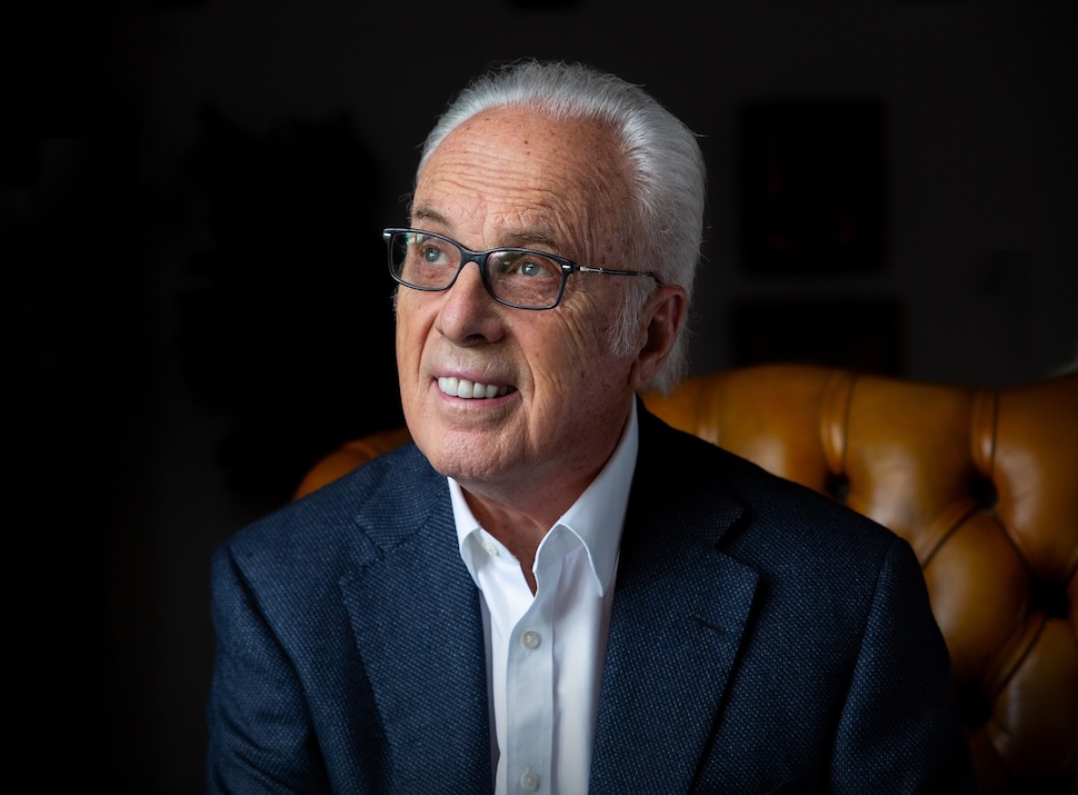 John MacArthur sits in a brown leather chair