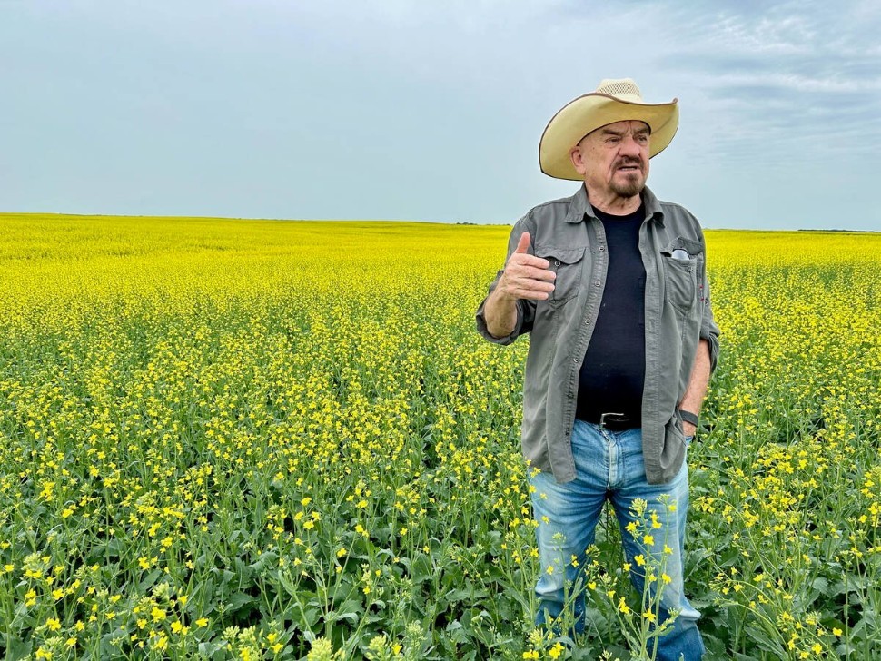  Robert Andjelic, who owns 248,000 acres of cropland in Canada, stands in a massive field of canola south of Whitewood, Sask
