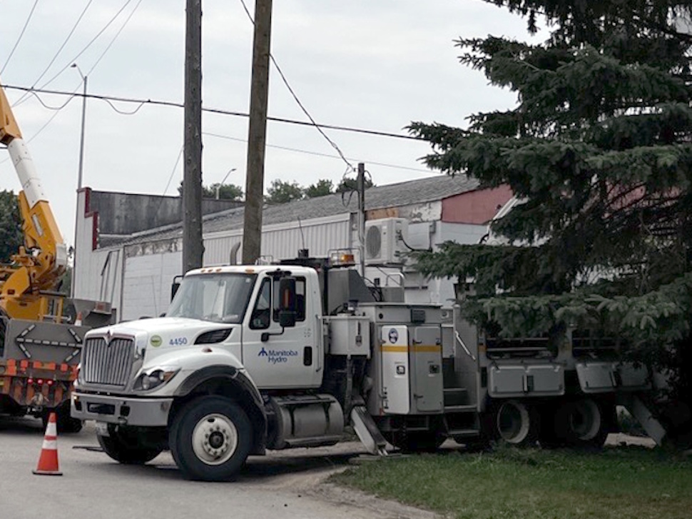 A Manitoba Hydro truck parked near a residential area during vegetation management work.