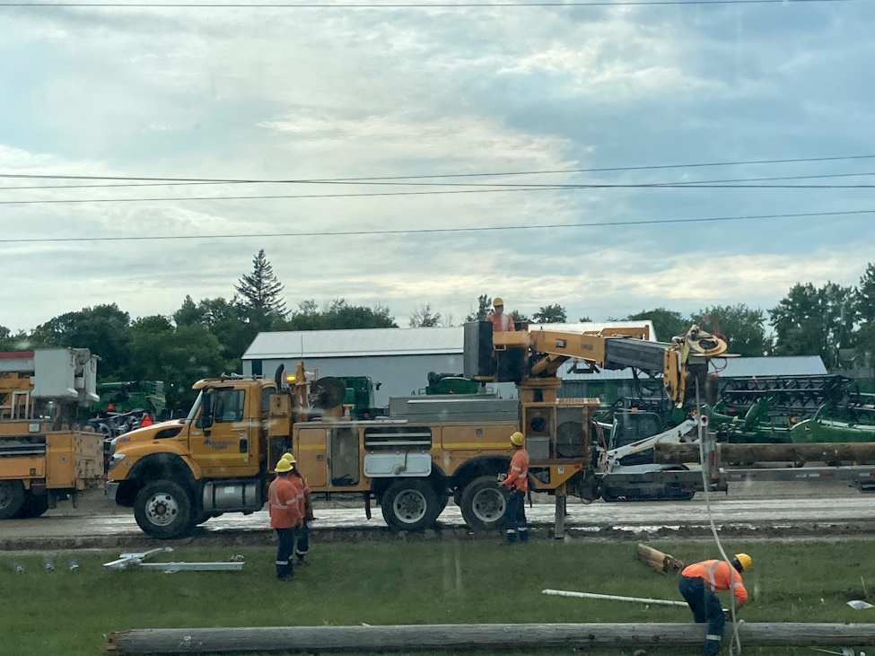 hydro crews working to restore a pole