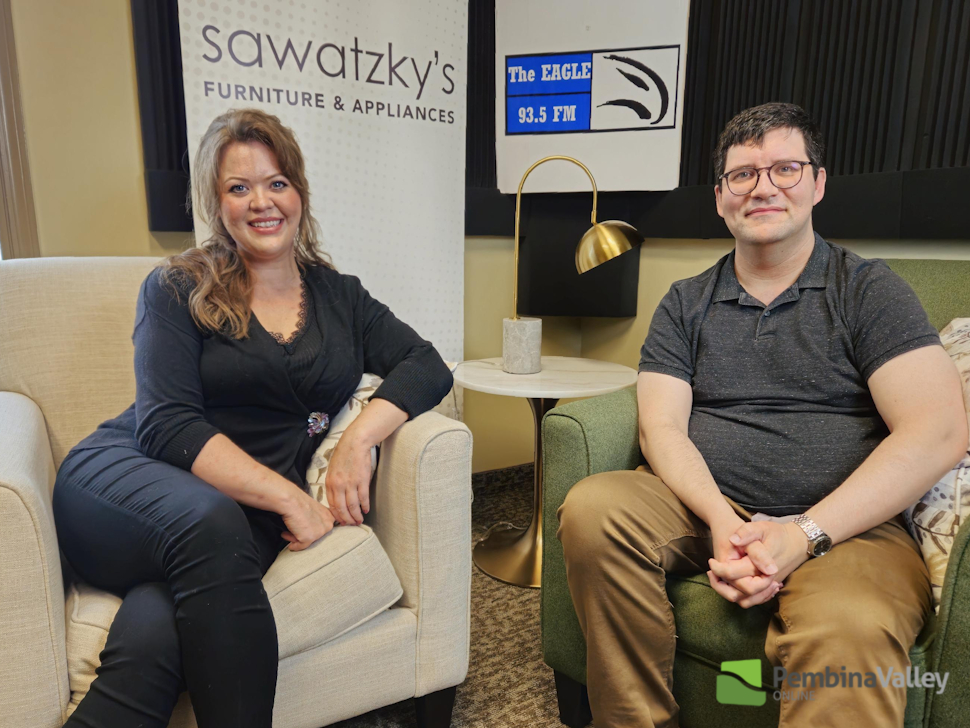two people sit in a studio 