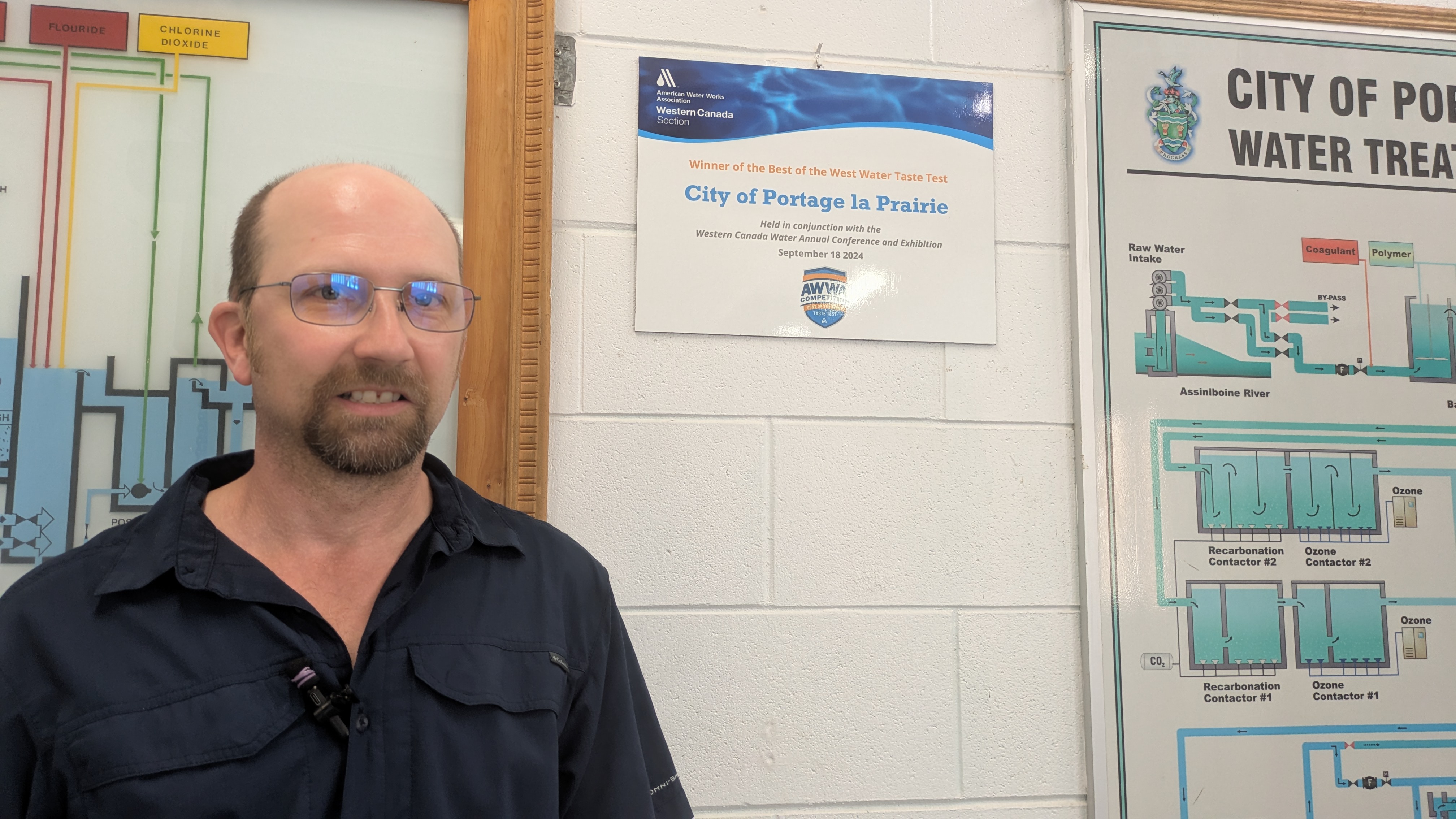 Jared Smith beside award for best-tasting water