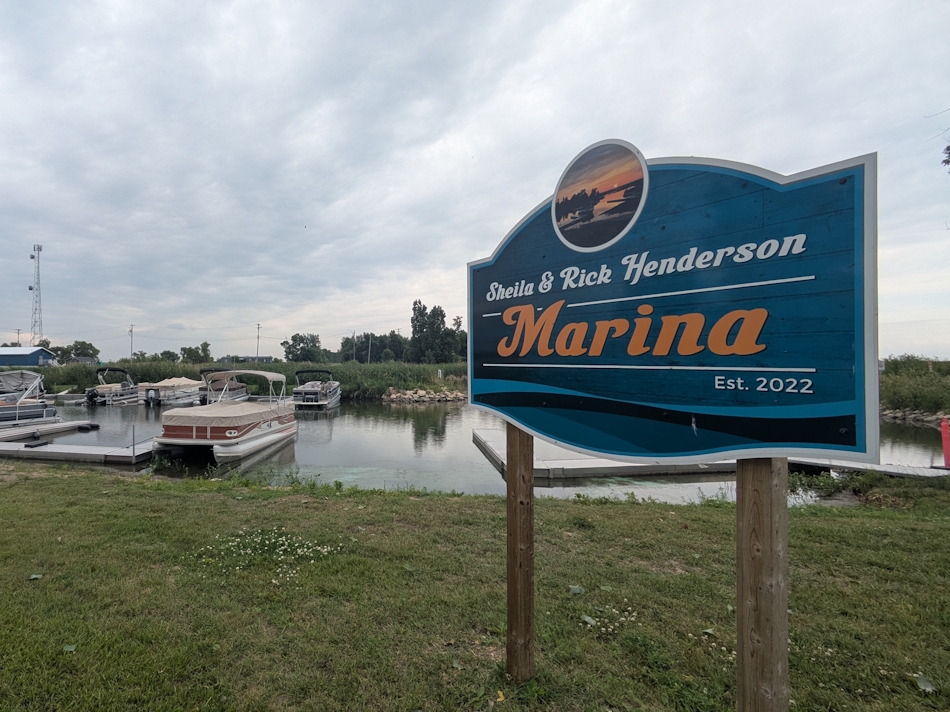 Sheila and Rick Henderson Marina showing sign and marina to the left in the background