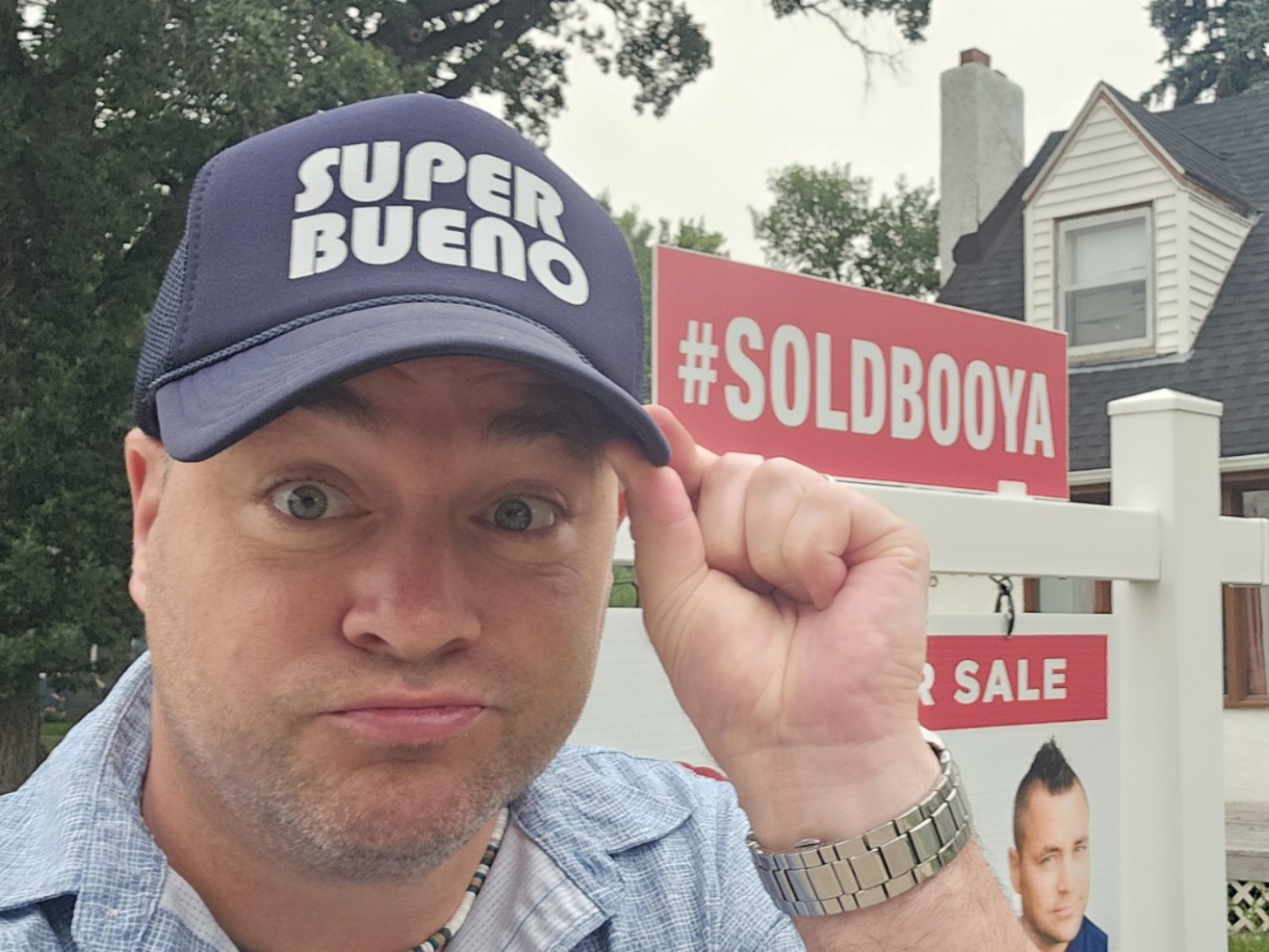 Peter Bracken in front of a sold home