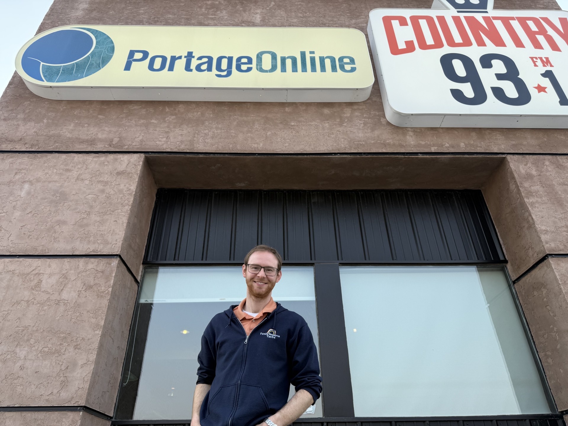 Peter Thiessen, Program Director for the Family Resource Centre, standing outside the radio station. PortageOnline/Jared Thiessen