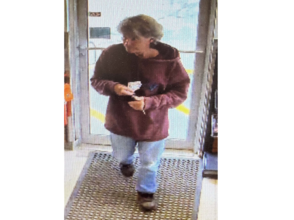 a middle aged man walking into a story with camera surveillance