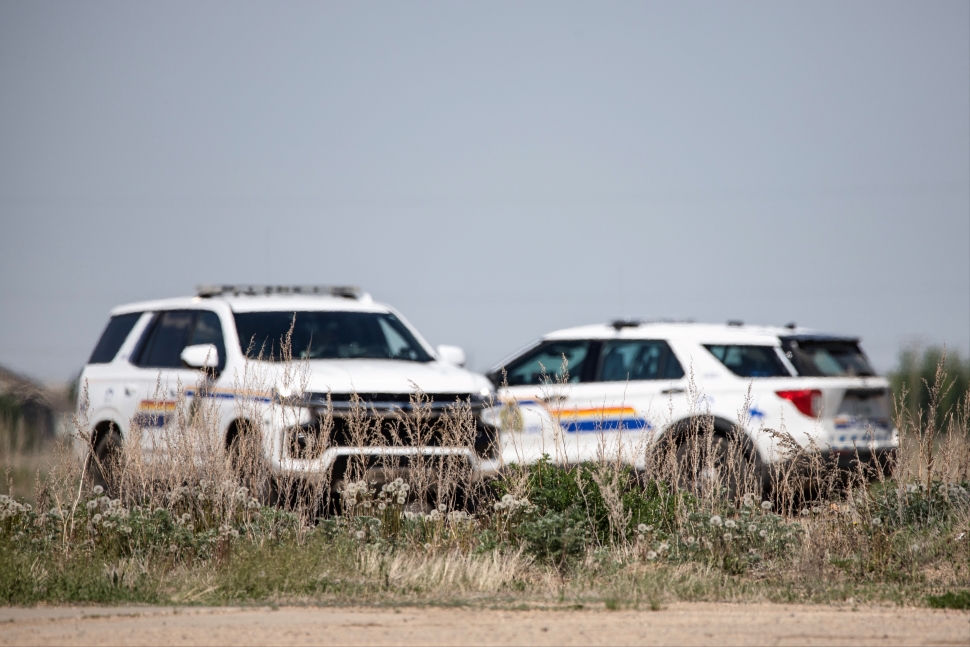 Two RCMP cruisers in a rural location.